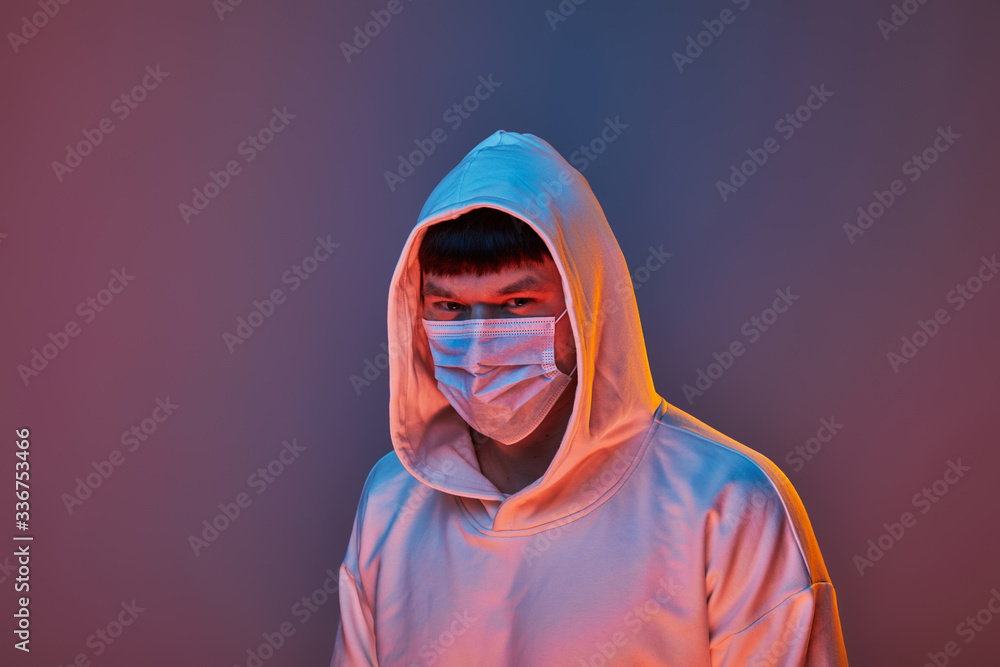 close-up of a man in a medical mask and white clothes on a colored background close-up of a man in a medical mask and white clothes on a colored background