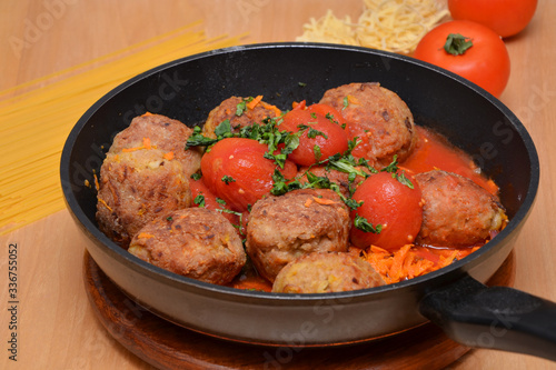 nutritious dinner in a pan meat meatballs with tomatoes and herbs
