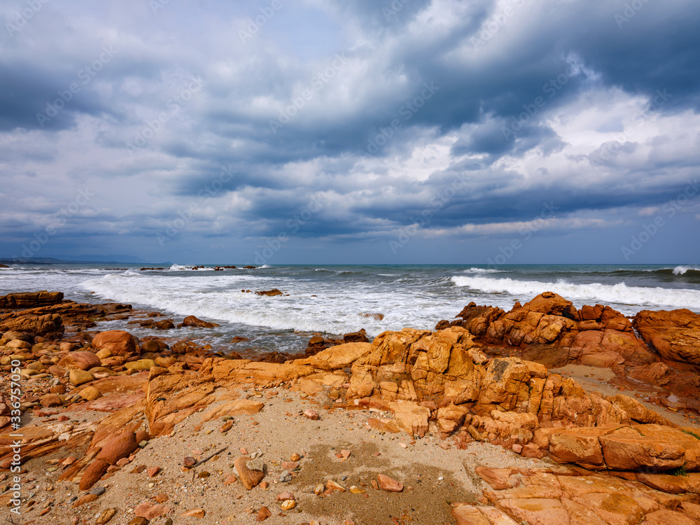Fototapeta premium Beach with red porphyry rocks in the immense Mediterranean scrub of Ogliastra, Sardinia, Italy