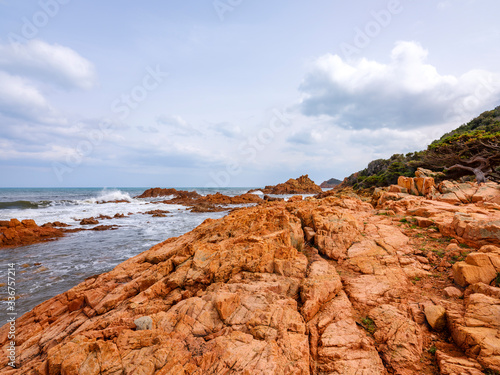 Wild and suggestive east coast of Sardinia. Beach with red porphyry rocks in the immense Mediterranean scrub of Ogliastra  Sardinia  Italy