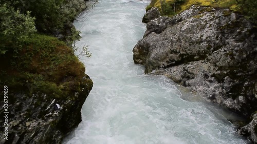 River which is located near path to the Briksdalsbreen (Briksdal) glacier. The melting of this glacier forms waterfall and river with clear water. Jostedalsbreen National Park. Norway. photo