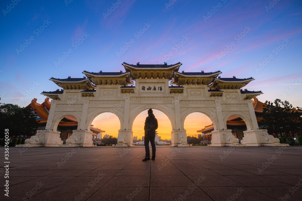 Young man traveller standing in front of National Chiang Kai-shek Memorial Hall , Taipei, Taiwan