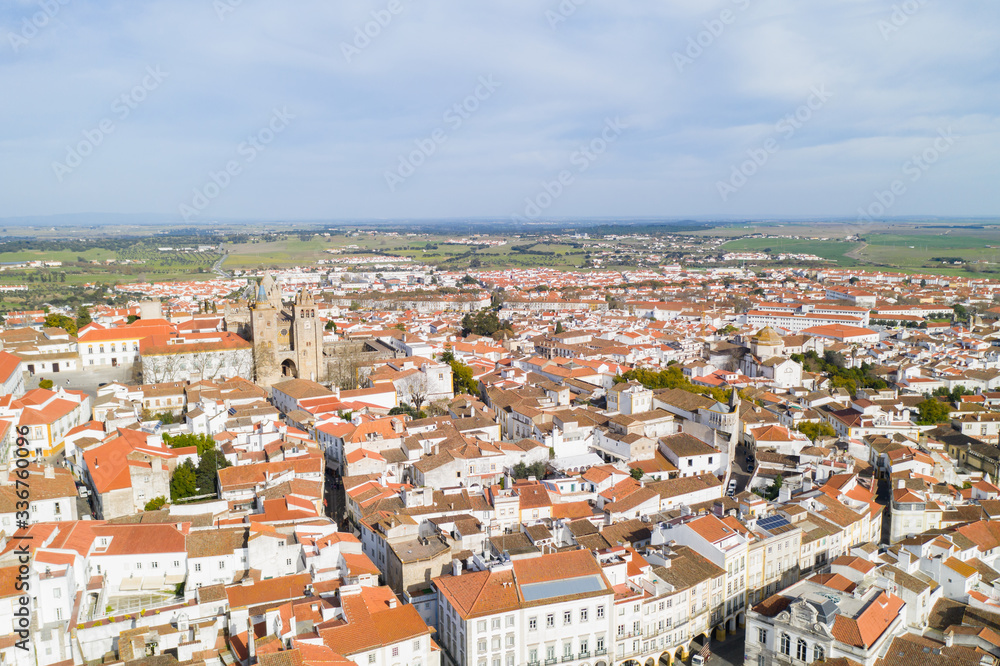 Evora drone aerial view on a sunny day with historic buildings city center and church in Alentejo, Portugal