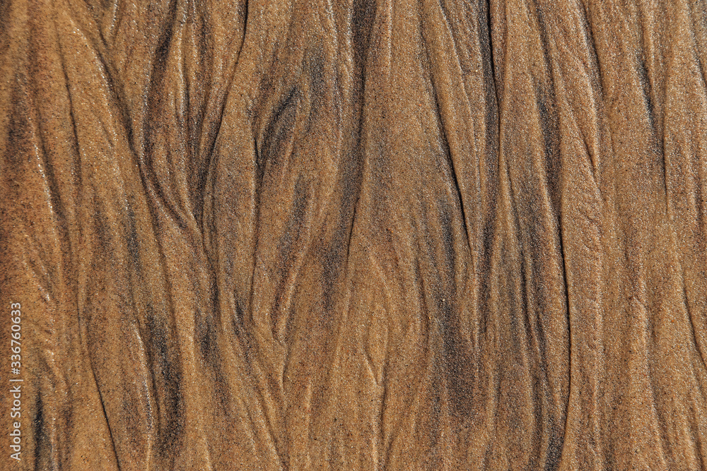 The texture of sea sand with traces of smudges The texture of sea sand with traces of smudges