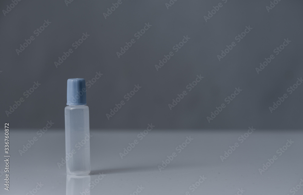 camping small container with a purple cap for contact lens solution camping small container with a purple cap for contact lens solution