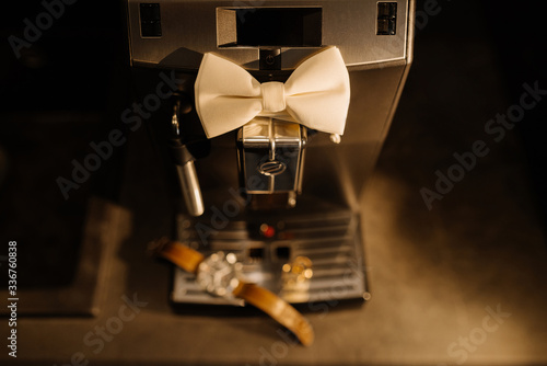 Wedding details. Groom accessories. Coffee machine, watch, rings, and bowtie