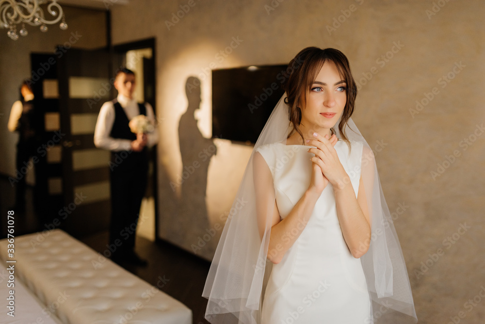 Naklejka premium Bride and groom morning. The first meeting of the bride and groom. First look of wedding couple in the morning. Wedding couple in the hotel. Bride and groom.