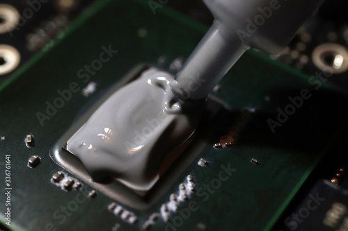 Applying thermal paste to the processor microchip.