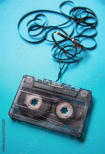 Cassette tape on a blue background with the tape twisted