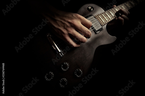 boy playing music on guitar, closeup