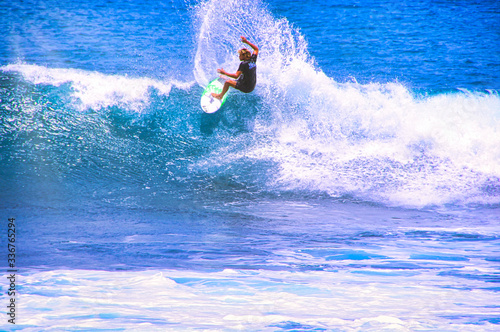 Photography Man catching an ocean wave near the coast