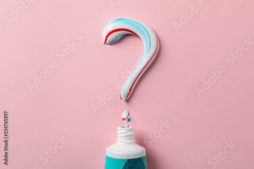 Bild auf Leinwand Question mark made of toothpaste and tube on pink background, copy space