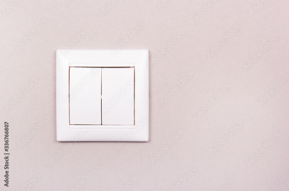 White plastic switch on gray background. White two-button switch. White plastic switch copy space White plastic switch on gray background. White two-button switch. White plastic switch copy space