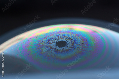 The reflection on the surface of a soap bubble looks like a planet. 
