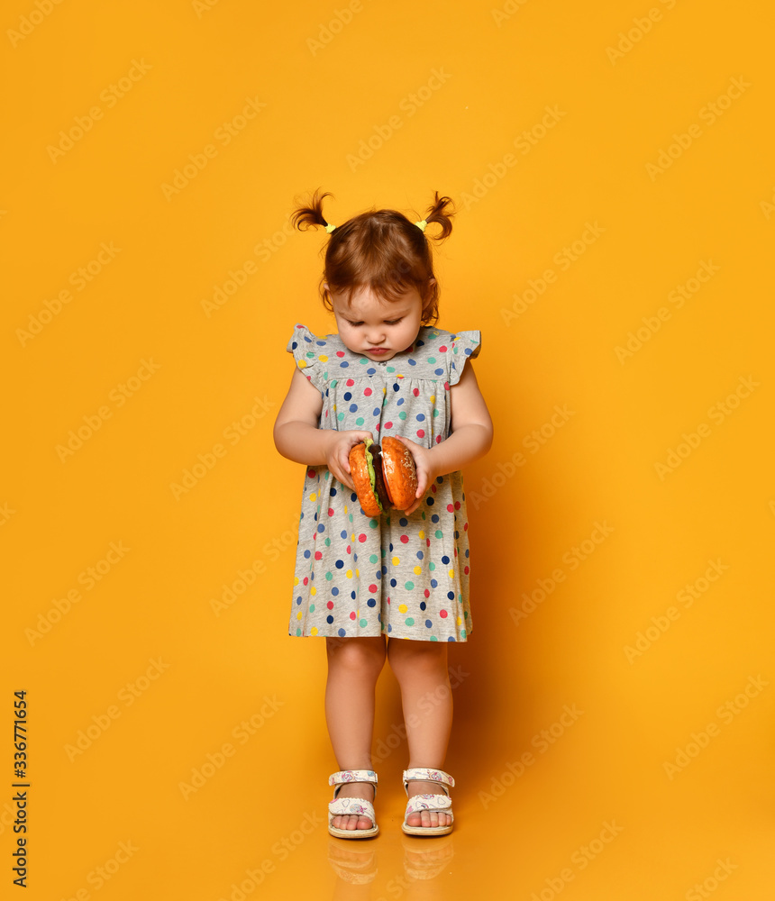 Little girl with hamburger in her hands. Little girl with hamburger in her hands.