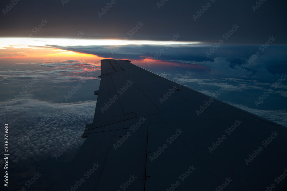 cloudy sunset sky over plane wing