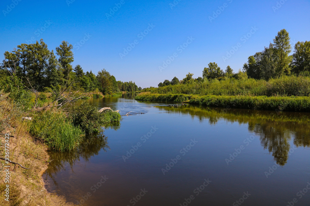 Dawn on the bank of a winding river.