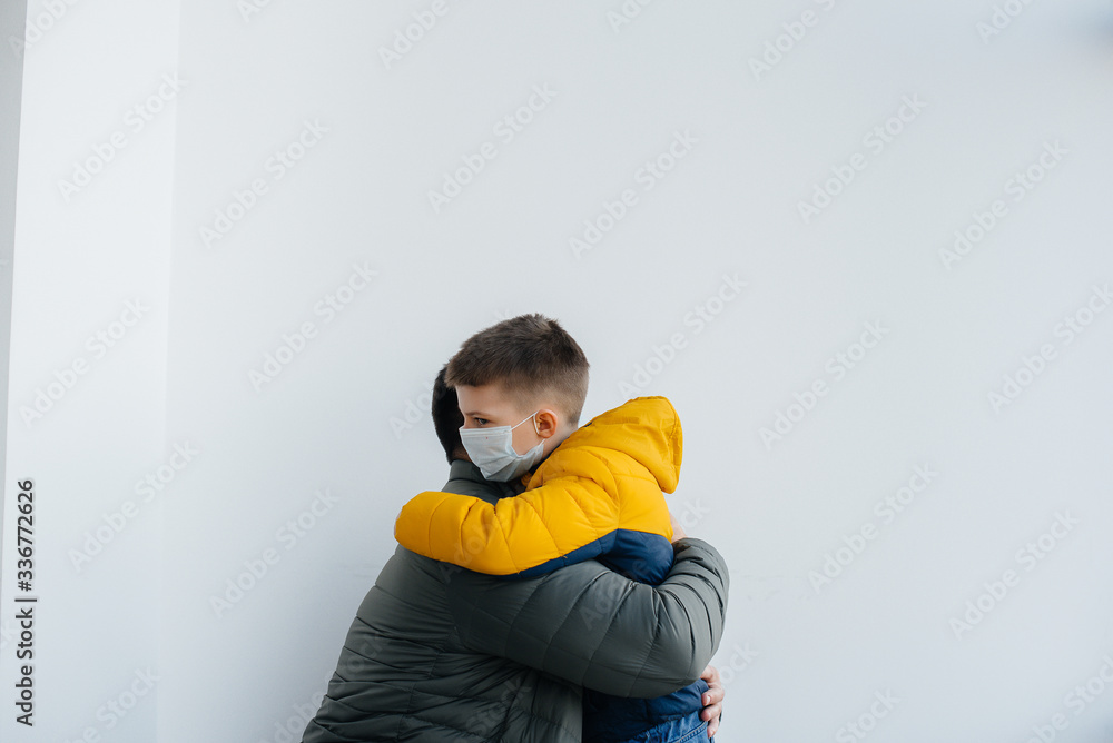 A father with his child stands in a mask during the quarantine. Pandemic, coronavirus A father with his child stands in a mask during the quarantine. Pandemic, coronavirus