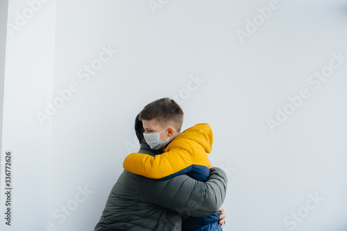 A father with his child stands in a mask during the quarantine. Pandemic, coronavirus © Andrii