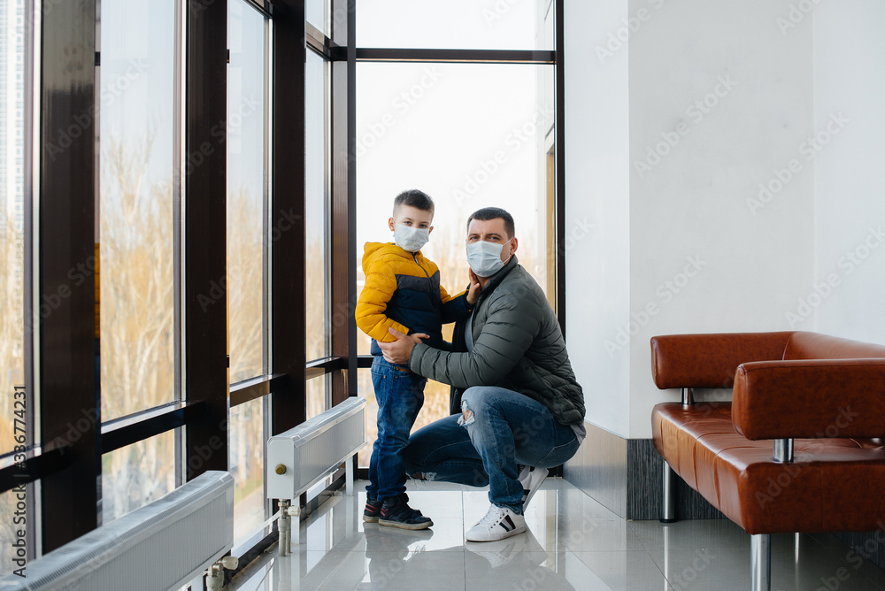 A father with his child stands in a mask during the quarantine. Pandemic, coronavirus A father with his child stands in a mask during the quarantine. Pandemic, coronavirus
