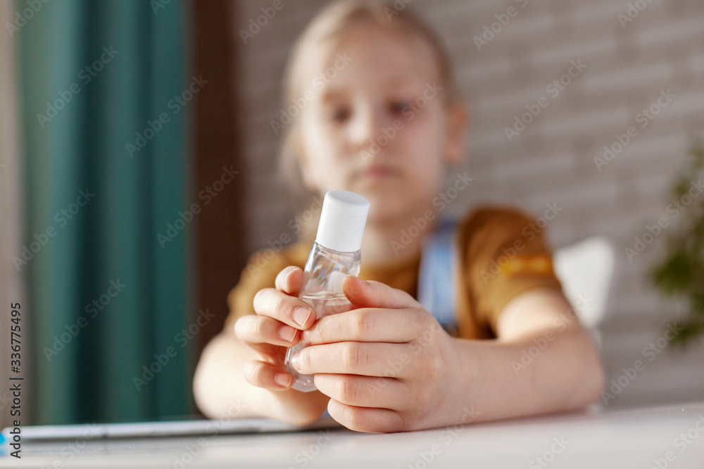 The girl is holding an antiseptic gel. Prevention, disinfection of hands, prevention of infection. The concept of a healthy lifestyle The girl is holding an antiseptic gel. Prevention, disinfection of hands, prevention of infection. The concept of a healthy lifestyle