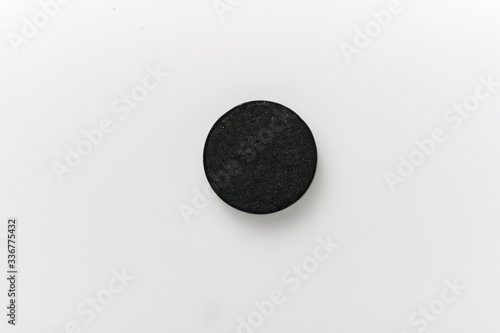Close-up of white pill isolated on white background.