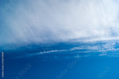 Contrast of smooth blue saturated sky and soft loose white clouds. Sky photo