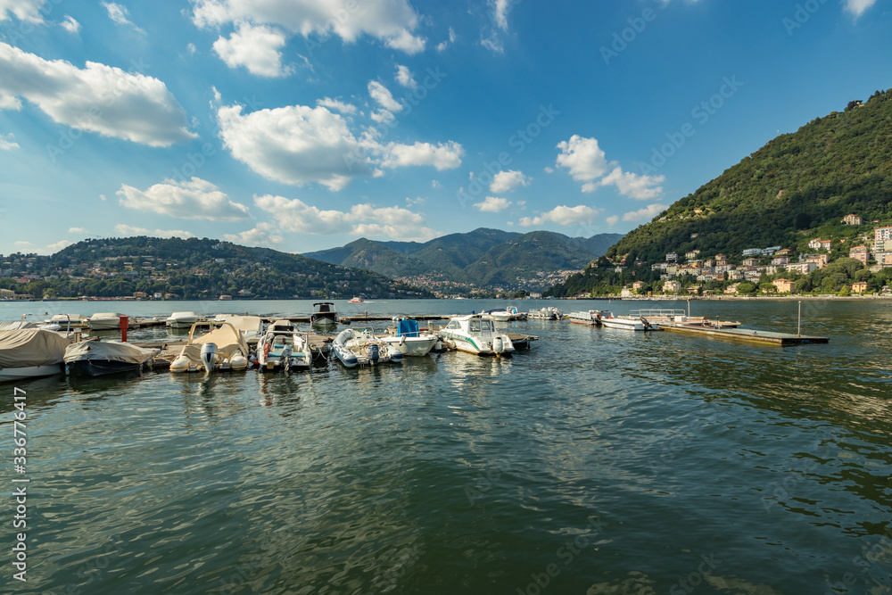 Como, ITALY - August 4, 2019: Marina in the Lake Como in the center of beautiful Italian Como city. Warm sunny summer day in very popular holiday destination Como, ITALY - August 4, 2019: Marina in the Lake Como in the center of beautiful Italian Como city. Warm sunny summer day in very popular holiday destination