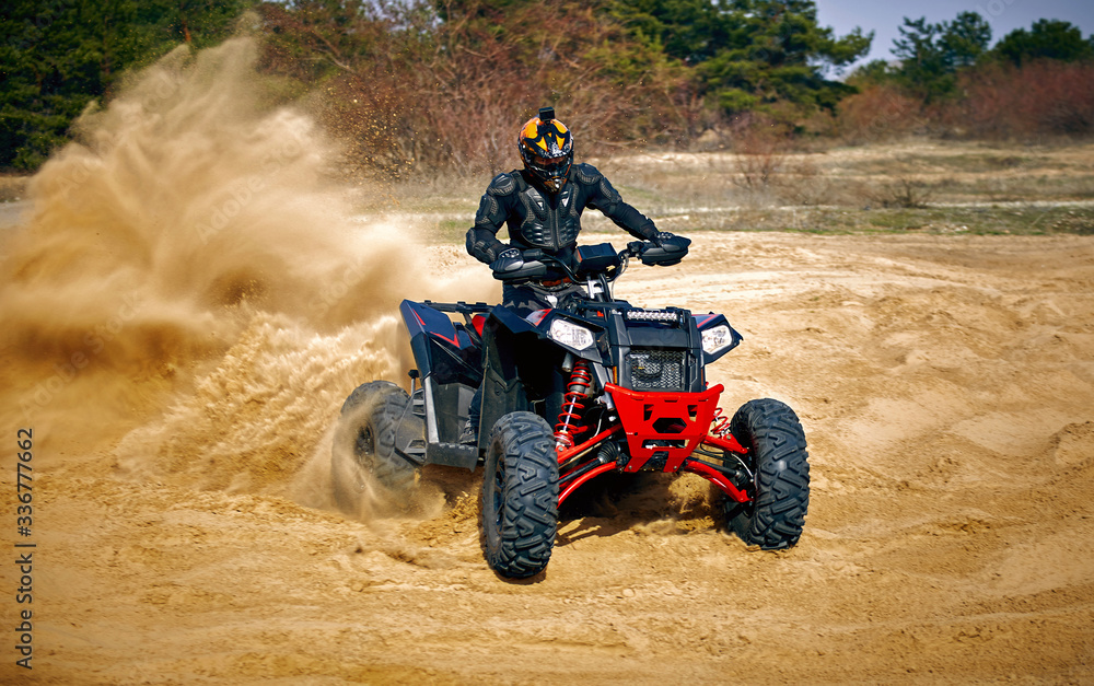 Racing in the sand on a four-wheel drive quad. Racing in the sand on a four-wheel drive quad.