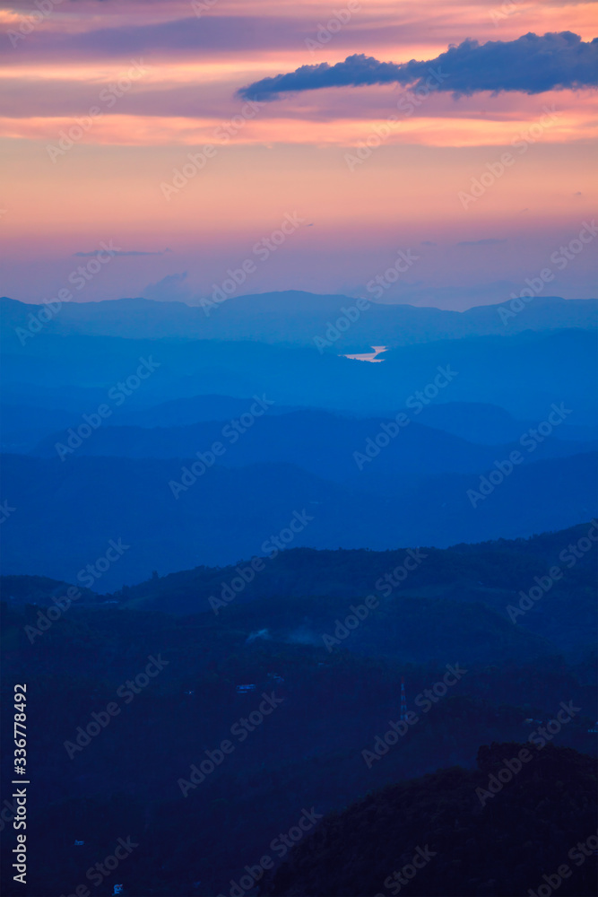 Indian sunset in South India Niligiri mountains in Western Ghats. Pothamedu viewpoint, Munnar, Kerala, India