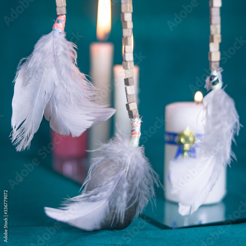 DREAM CATCHER FEATHERS WITH CANDLES AND GREEN TABLECLOTH