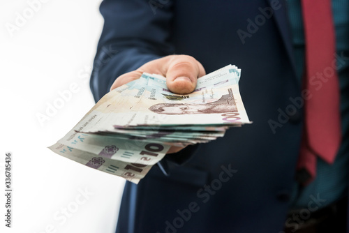 businessman gives bribe or pay, in isolation. UAH. 1000 new banknote Ukrainian money