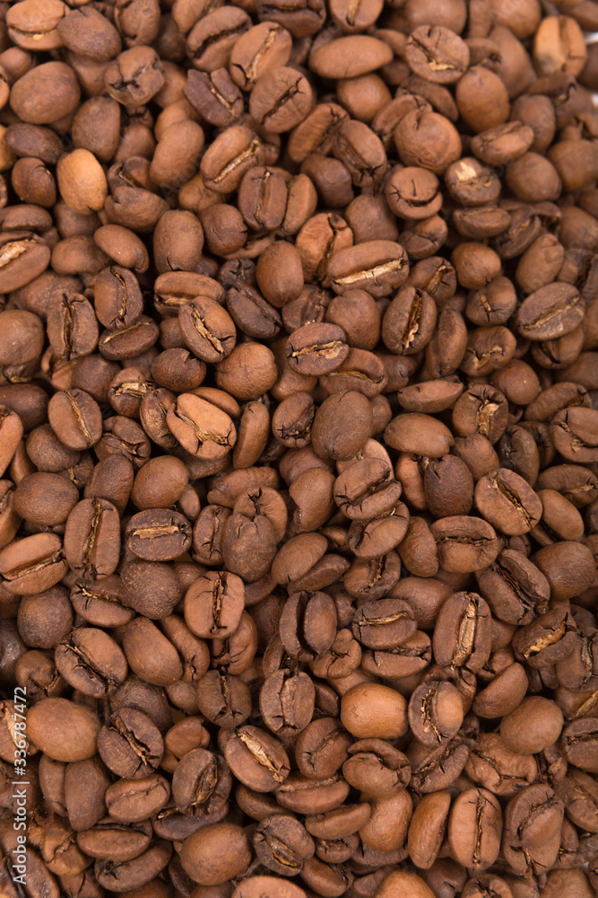 Coffee beans laid out on a white background surface Coffee beans laid out on a white background surface