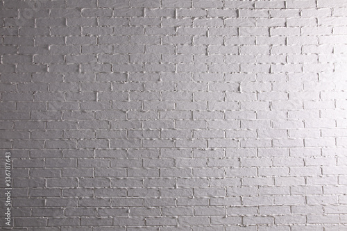 White brick wall with thick uneven joints.