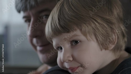 A small child hugs his father.  a little boy shows love for the folder. 