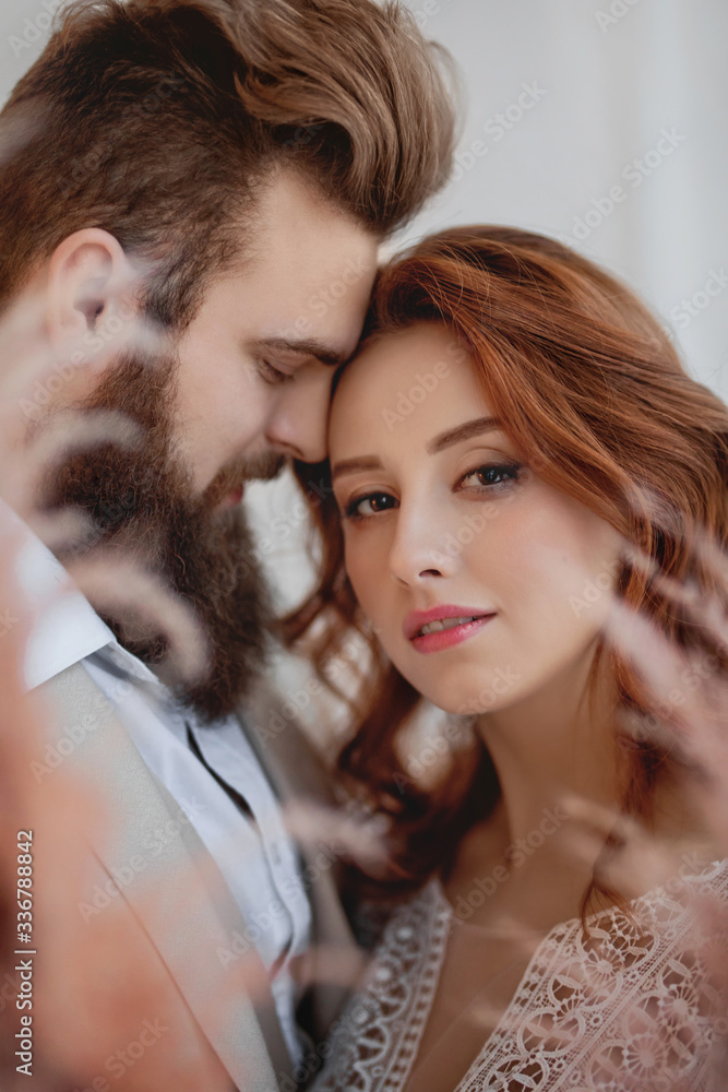 close portrait of a red-haired girl and a bearded guy