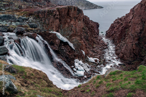 Long exposure waterfall. Waterfall on the Kola Peninsula of the Barents Sea. The nature of the Arctic Circle