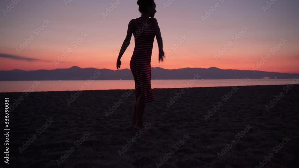 Sexy flexible girl in red summer dress dancing at the sea beach, barefoot female moving her body in the rhythm of disco music. Celebration at the beach party, summer vacation, dancing on amazing Sexy flexible girl in red summer dress dancing at the sea beach, barefoot female moving her body in the rhythm of disco music. Celebration at the beach party, summer vacation, dancing on amazing