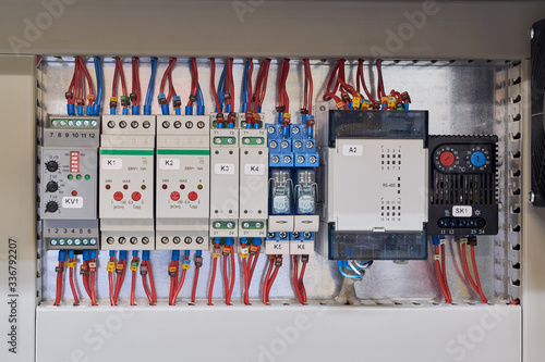 Digital input module, voltage, skew and phase sequence relay, level relay, thermistor protection relay, intermediate relays and thermostat in the electrical Cabinet. photo