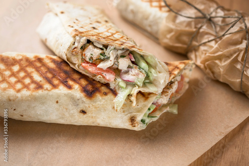 Doner kebab Shawarma cut with filling on parchment paper