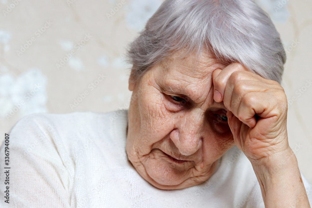 Elderly woman thought about something. Sad female with gray hair and wrinkled skin, concept of headache, memories, loneliness and old age Elderly woman thought about something. Sad female with gray hair and wrinkled skin, concept of headache, memories, loneliness and old age