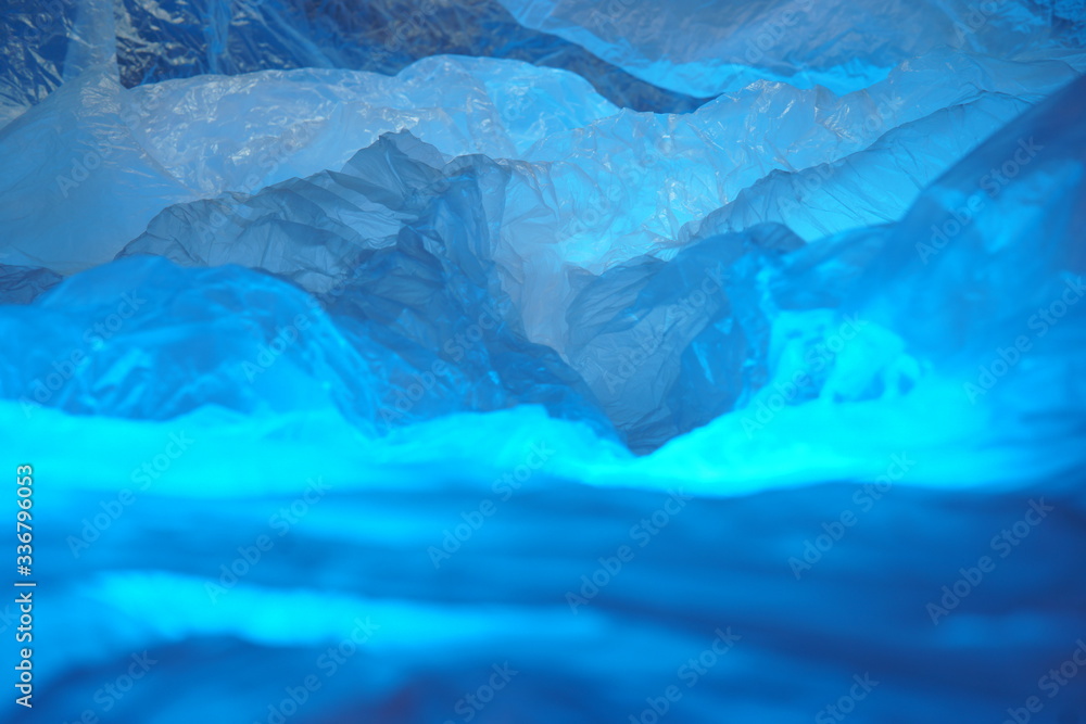 Obraz premium A Photo Depiction of a Fantasy Mountain Region, Showing a Scrunched Plastic Sheet with a Range of Blurred Blue Ridge Peaks. 