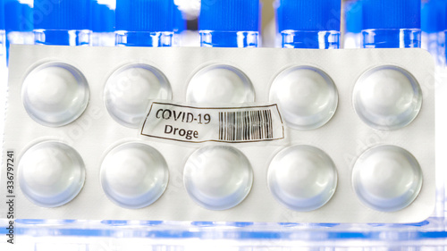A round drug Covid-19 Droge written in German pack of medicine for coronavirus