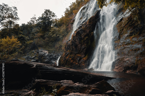 Big waterfall that flow through large rocks.