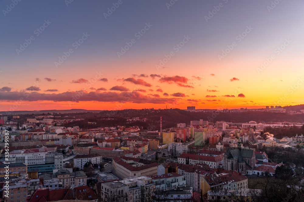 Fototapeta Day to night time-lapse when Brno city square and surroved area goes from sunset when sunshine change city colors to orange through sunset to night when city light goes on captured 4k high resolution