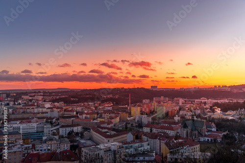 Day to night time-lapse when Brno city square and surroved area goes from sunset when sunshine change city colors to orange through sunset to night when city light goes on captured 4k high resolution © Lukas