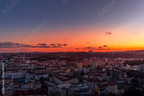 Day to night time-lapse when Brno city square and surroved area goes from sunset when sunshine change city colors to orange through sunset to night when city light goes on captured 4k high resolution