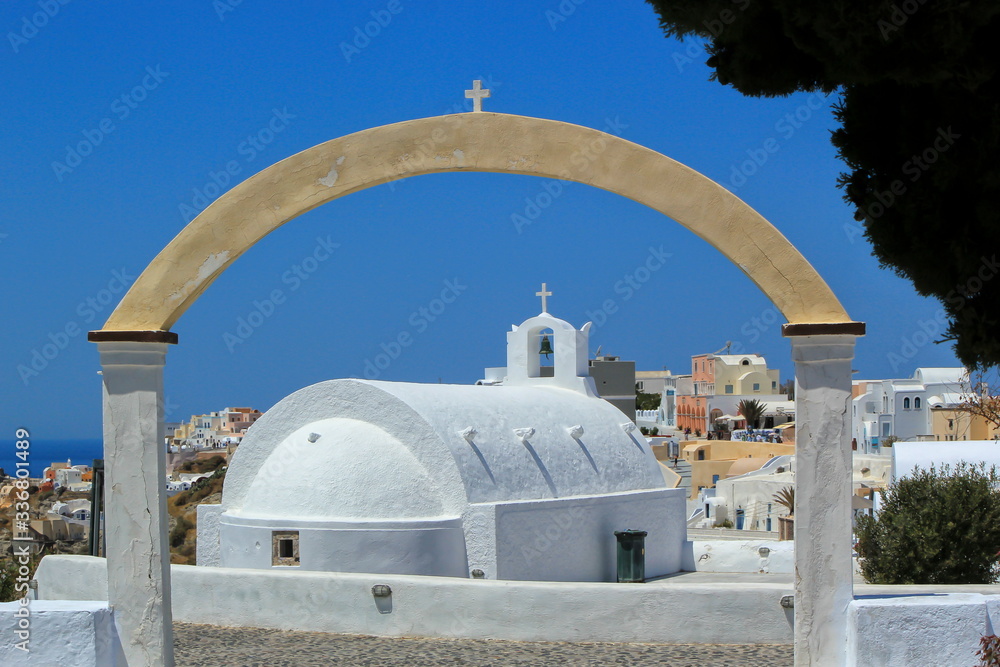 Small white church in Oia by day, Santorini island, Greece