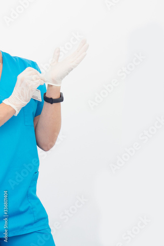 doctor in a suit puts on rubber gloves. Hand disinfection and washing