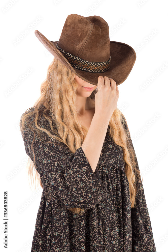 Girl dressed in a folk dress and a cowboy hat, isolate on a white background. Girl dressed in a folk dress and a cowboy hat, isolate on a white background.